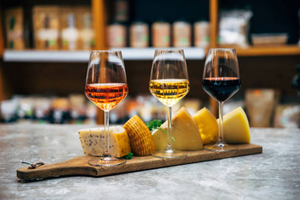 A selection of three wines paired with a variety of delectable cheeses for a perfect culinary experience